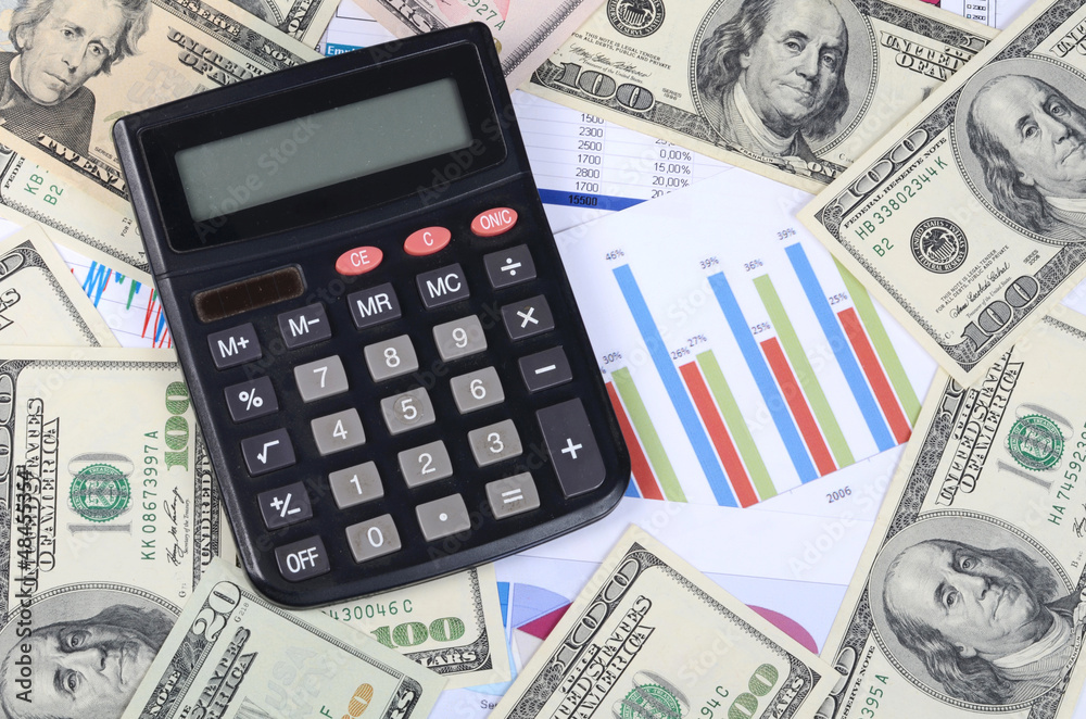 Banknotes of dollar with the calculator Banknotes of dollar with the calculator