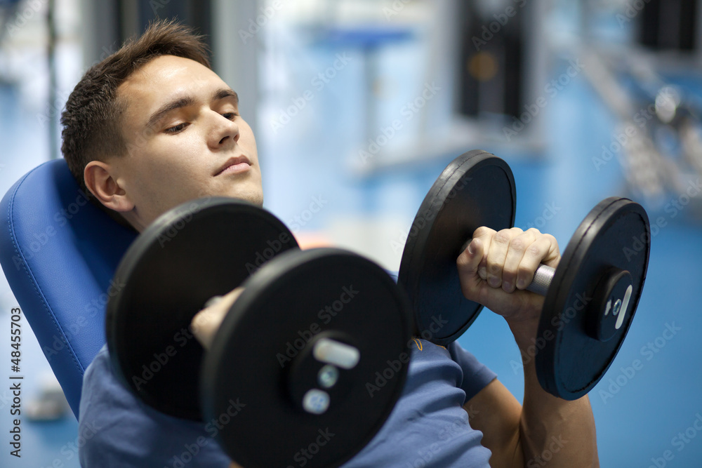 Handsome man with dumbbells