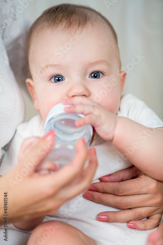 mother feeding by milk his ...