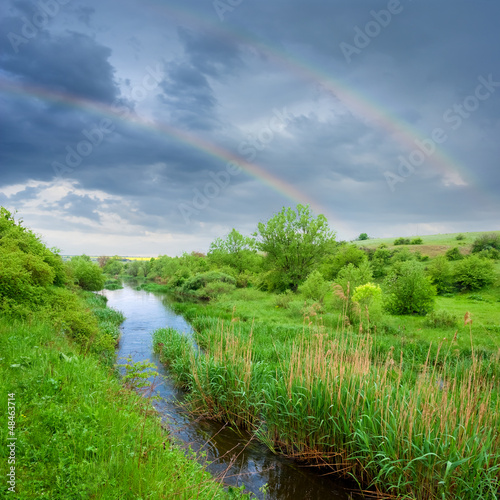 rainbow above a steppe river