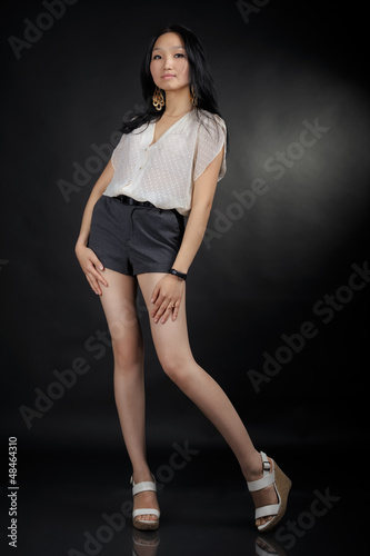 Asian girl in T-shirt and shorts © Igor Kovalchuk