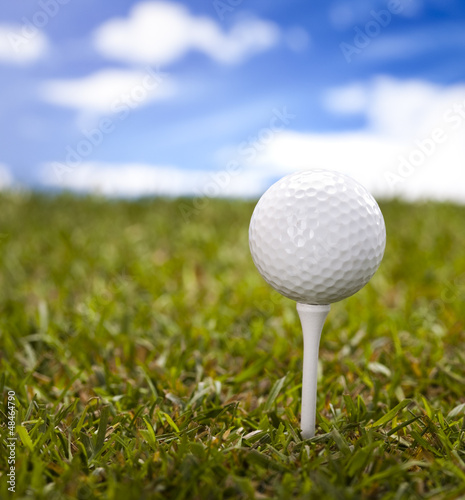 Golf ball on green meadow