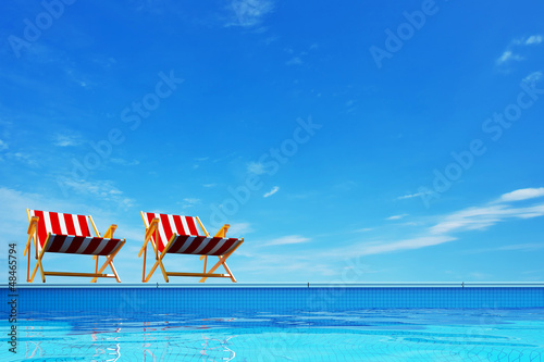 Swimming pool with beach chairs