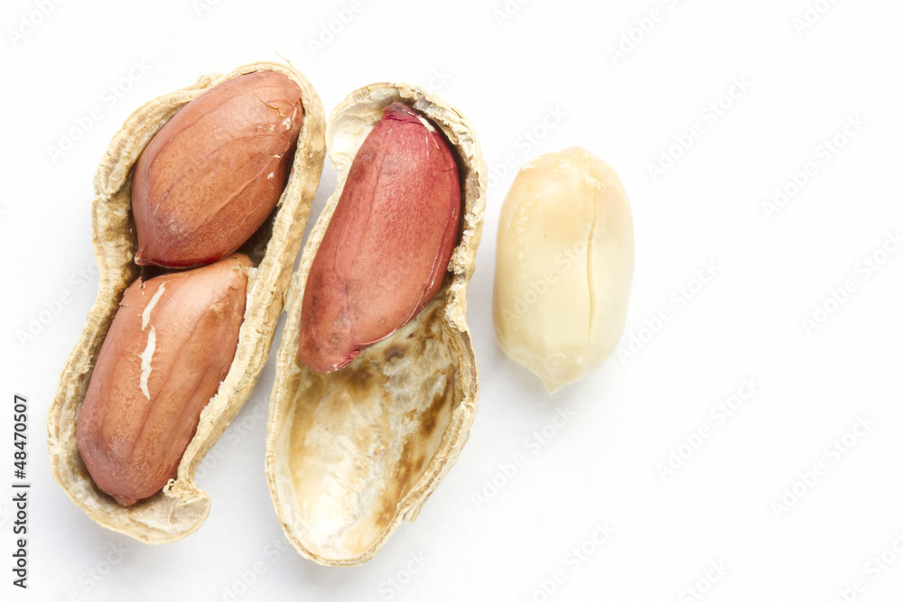 Peanuts on a white paper background Peanuts on a white paper background