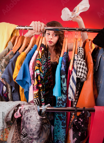 Nothing to wear concept, young woman deciding what to put on