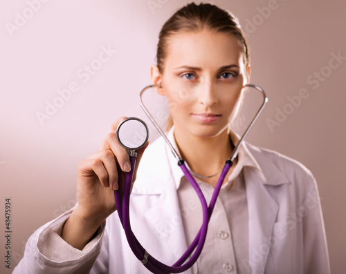 Close-up of female doctor using stethoscope