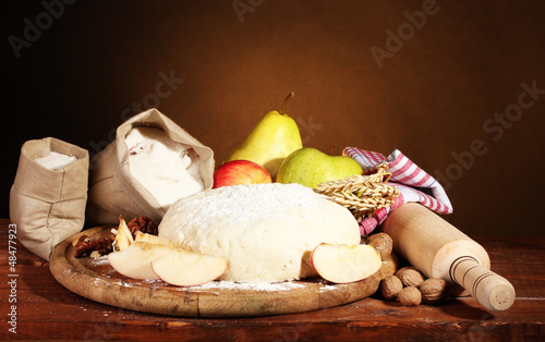 ingredients for homemade pie on wooden table on brown