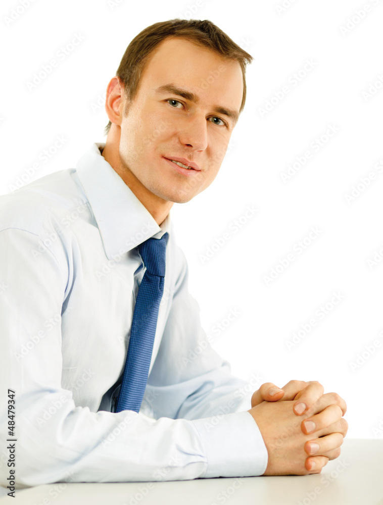 Portrait of a happy young businessman sitting on the desk Portrait of a happy young businessman sitting on the desk