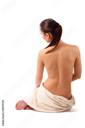 Back-view of a beautiful woman sitting on the floor