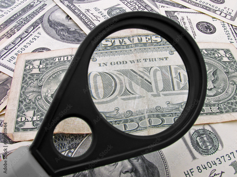 view on one dollar banknote through magnifying glass view on one dollar banknote through magnifying glass
