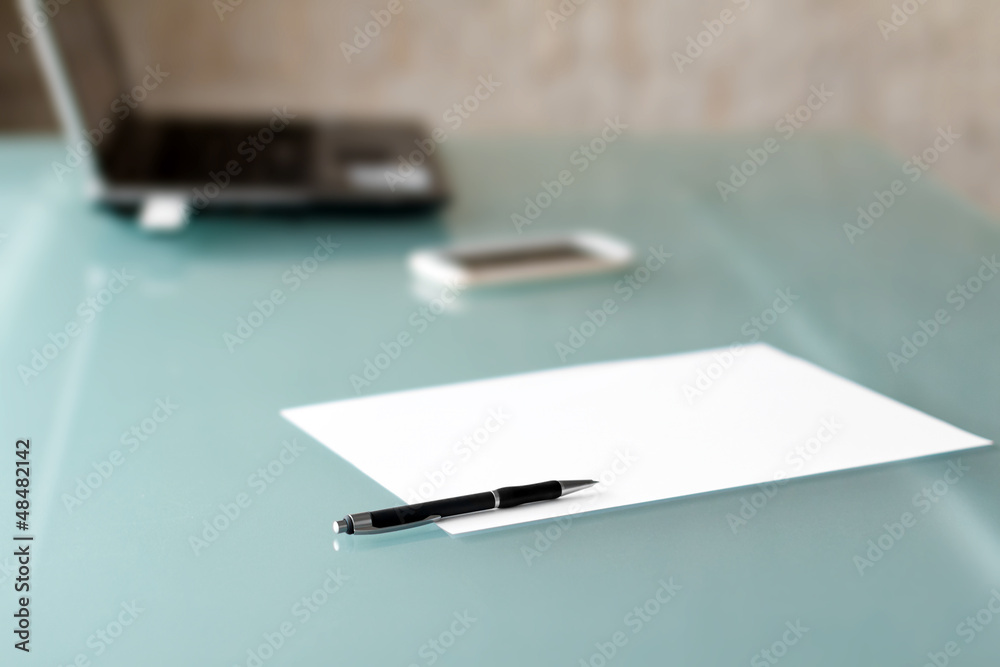 Paper with pen and laptop background Paper with pen and laptop background