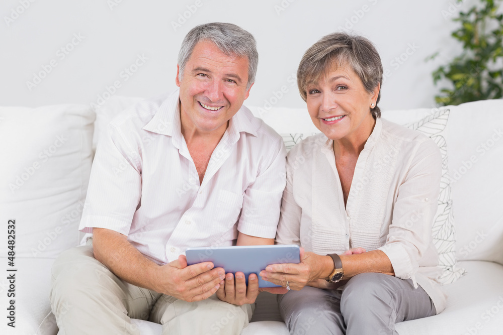 Old couple looking camera with tablet pc Old couple looking camera with tablet pc