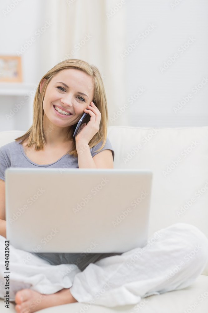 Portrait of casual woman using laptop and cellphone at home Portrait of casual woman using laptop and cellphone at home