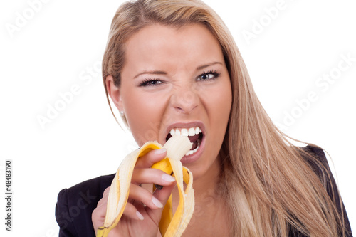 Woman eating a ripe banana