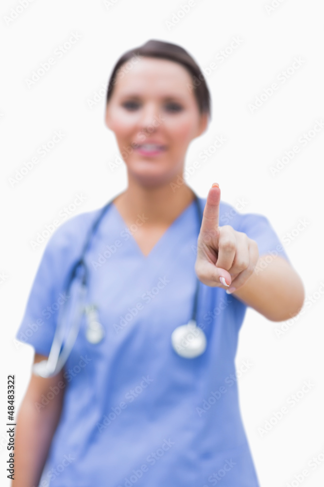 Portrait of female surgeon pointing at invisible screen Portrait of female surgeon pointing at invisible screen