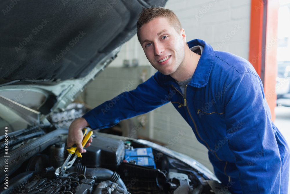 Male mechanic fixing car engine Male mechanic fixing car engine