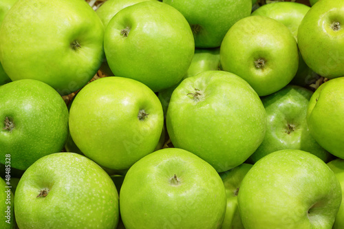 Closeup of many green juicy apple fruits in market