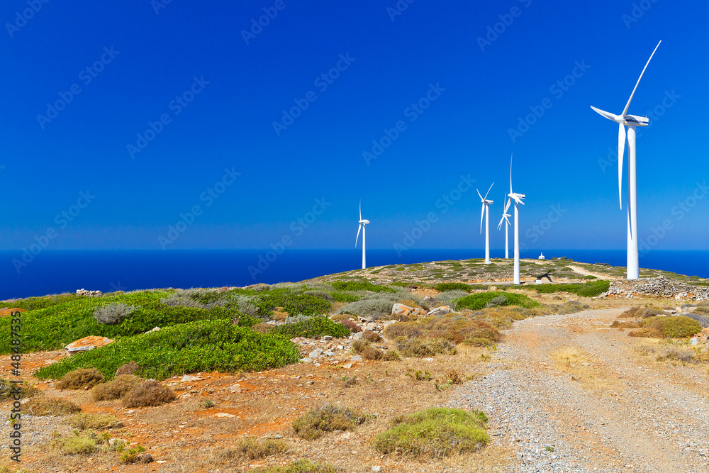 Wind turbines field over blue sky on Crete, Greece