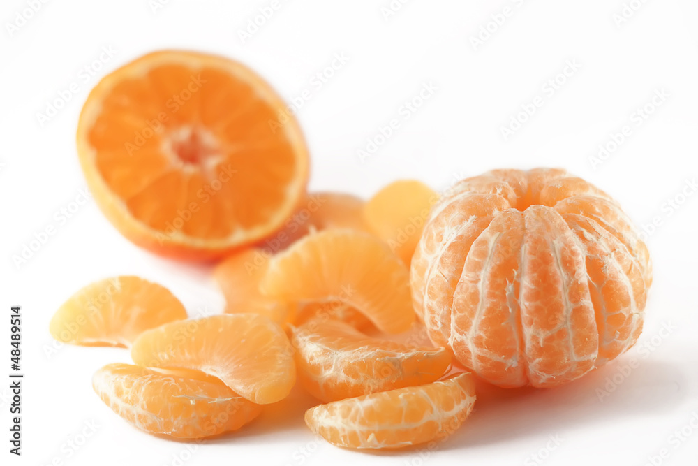peeled mandarin and slices on white peeled mandarin and slices on white