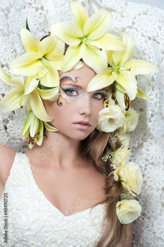 portrait of a beautiful girl with a garland of lilies and eustom photo