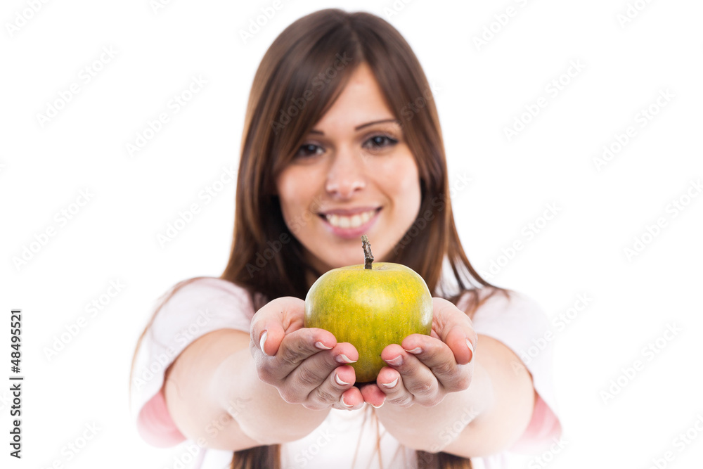 Smiling young woman with apple. Focus on apple Smiling young woman with apple. Focus on apple