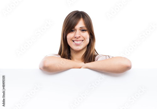 Portrait of a young woman with blank billboard