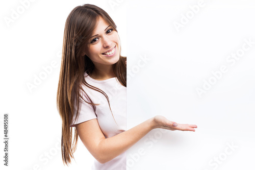 Portrait of a young woman with blank billboard