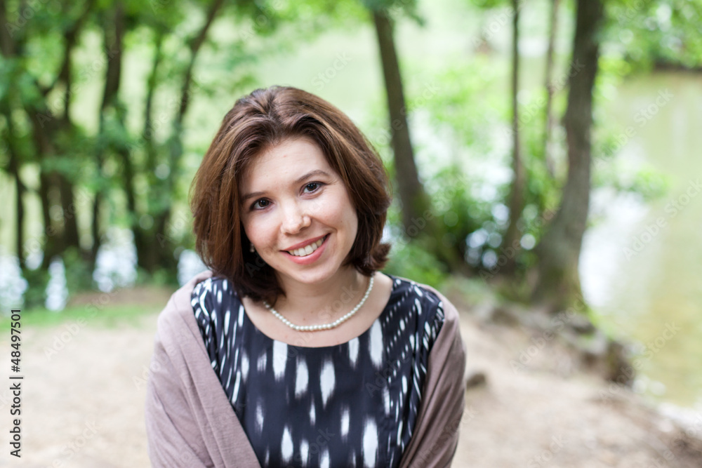 Beautiful young girl in summer forest