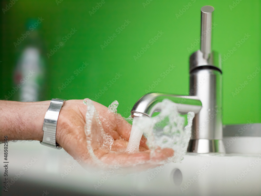 Fototapeta premium catching fresh water with hand