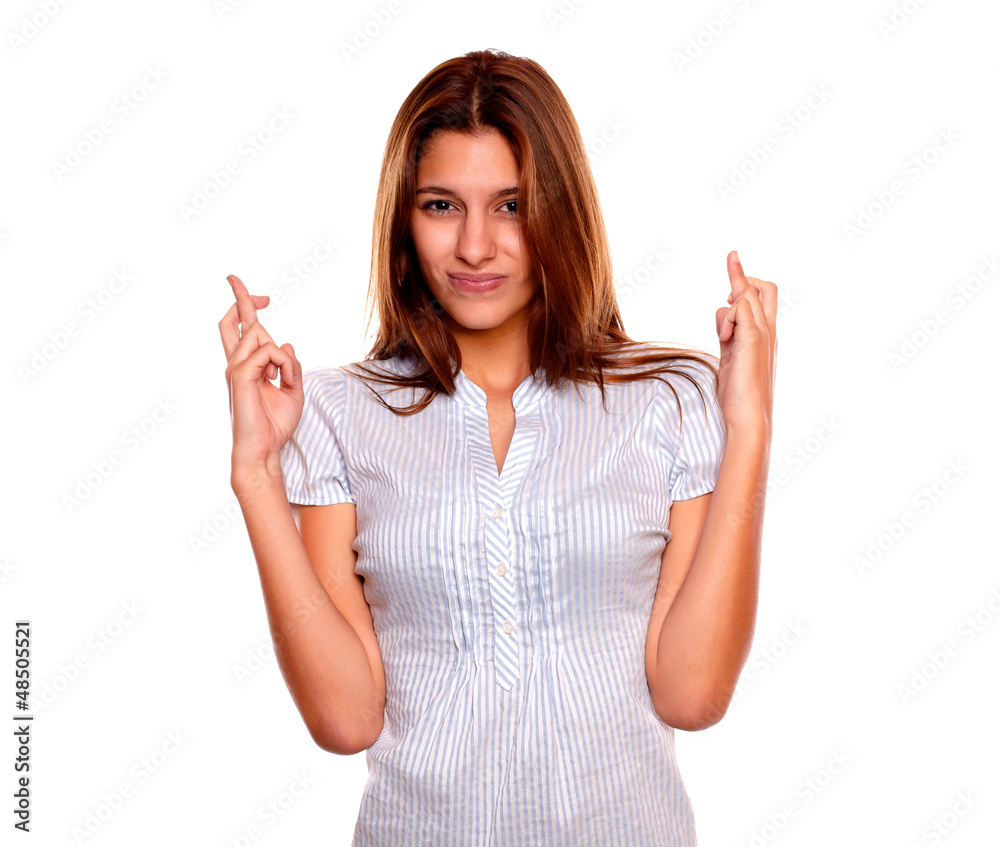 Pensive young female crossing her fingers Pensive young female crossing her fingers