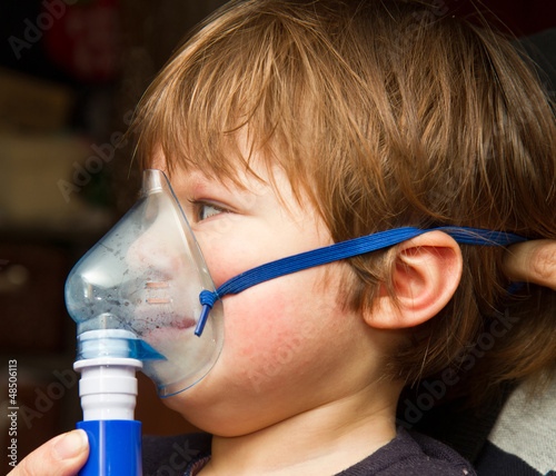 child taking respiratory, inhalation therapy.  photo