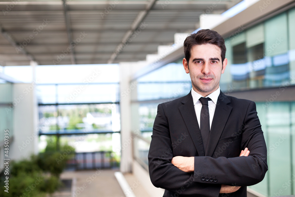 Portrait of a smiling young business man at modern office Portrait of a smiling young business man at modern office