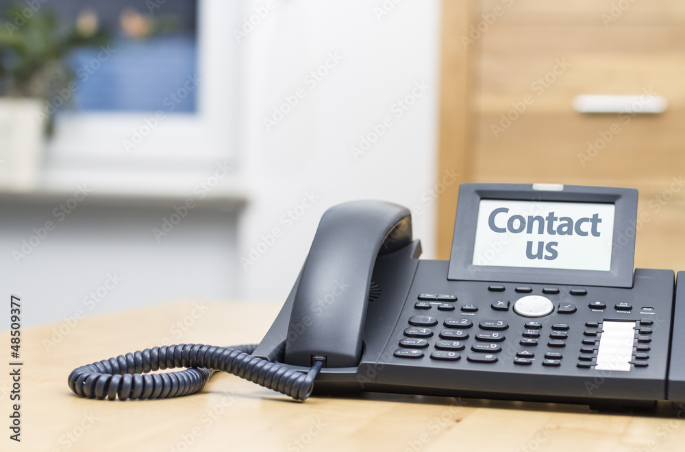 telephone with digital display on wooden desk telephone with digital display on wooden desk