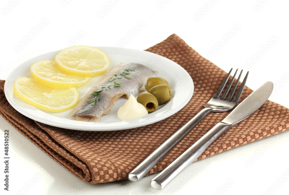 Dish of herring and lemon on plate isolated on white