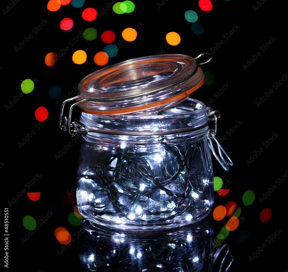Christmas lights in glass bottle on blur lights background Christmas lights in glass bottle on blur lights background