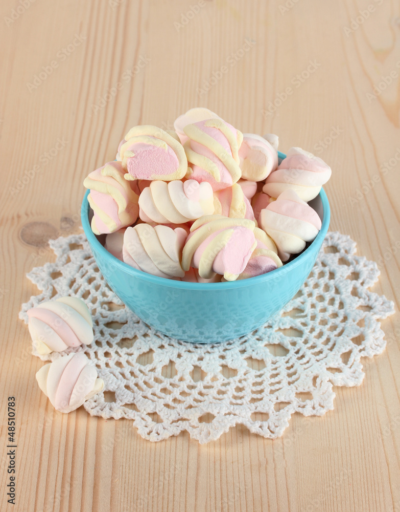 Gentle marshmallow in bowl on wooden table close-up Gentle marshmallow in bowl on wooden table close-up