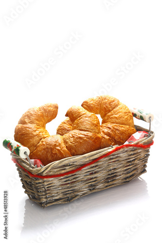 Crisp golden croissants in a basket