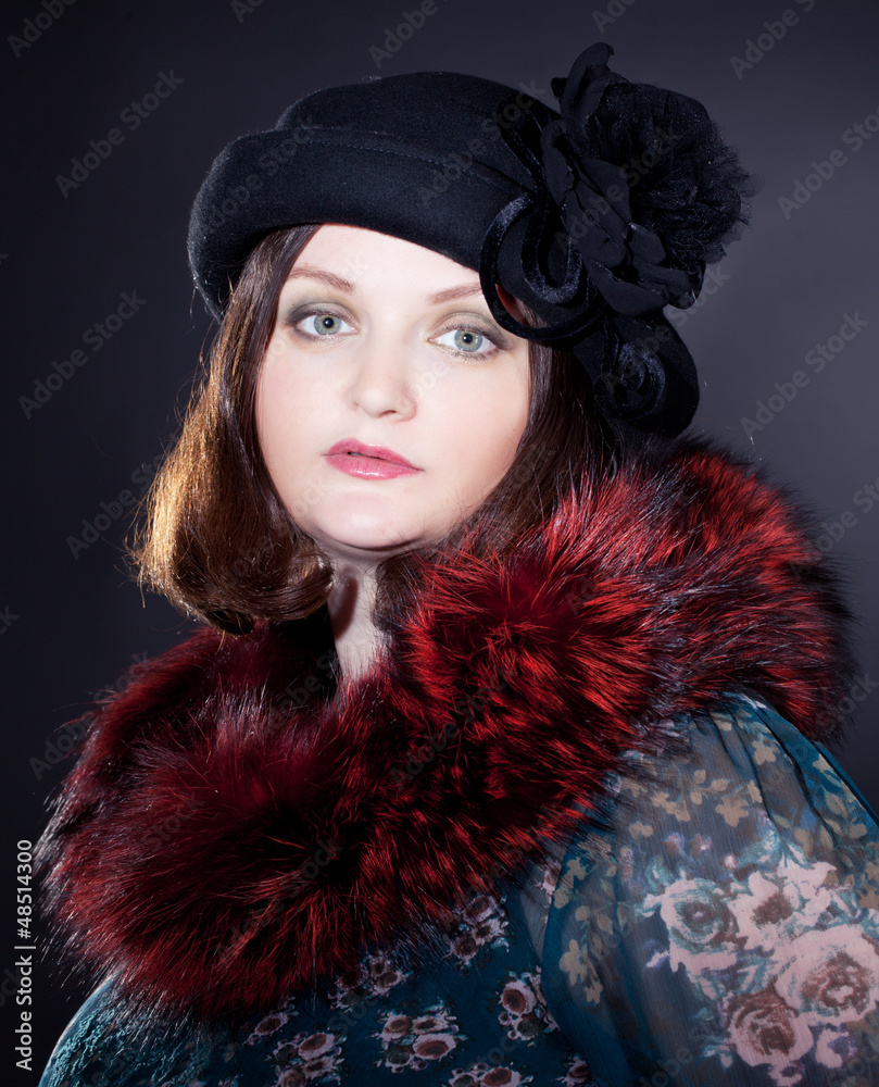 elegant woman wearing dark felt hat in retro style and fur