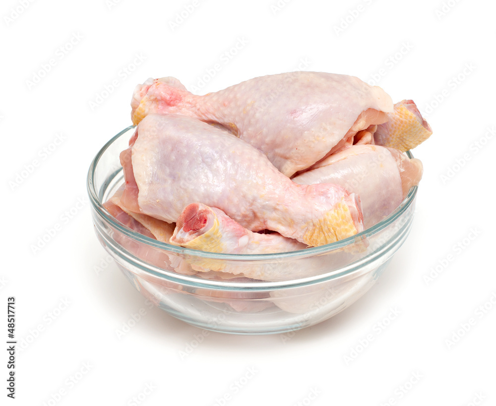 raw chicken legs in a glass bowl