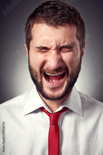 screaming man over grey background