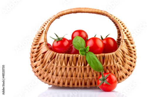 fresh tomatoes in basket isolated on white background