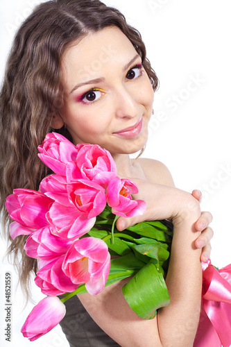 young woman with bouquet of flowers over white background photo