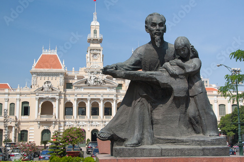 Statue Ho Chi Minh with a girl and Post Office in Saigon