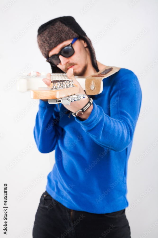 Handsome young man with electric guitar. Focus on guitar Handsome young man with electric guitar. Focus on guitar