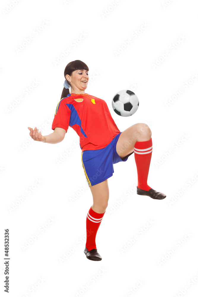 girl playing with soccer ball in studio