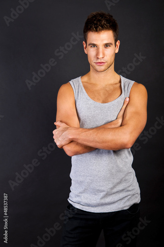 Handsome man casually leaning against the wall