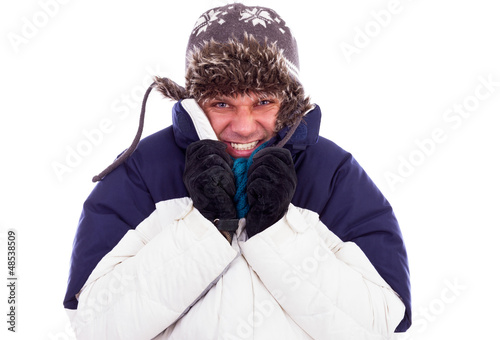 Bild auf Leinwand Young man with hat and coat  shivering  from cold