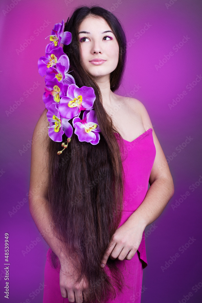 young beautiful girl with long hair and orchid young beautiful girl with long hair and orchid