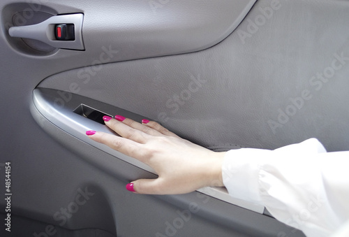 woman hand on car door handle