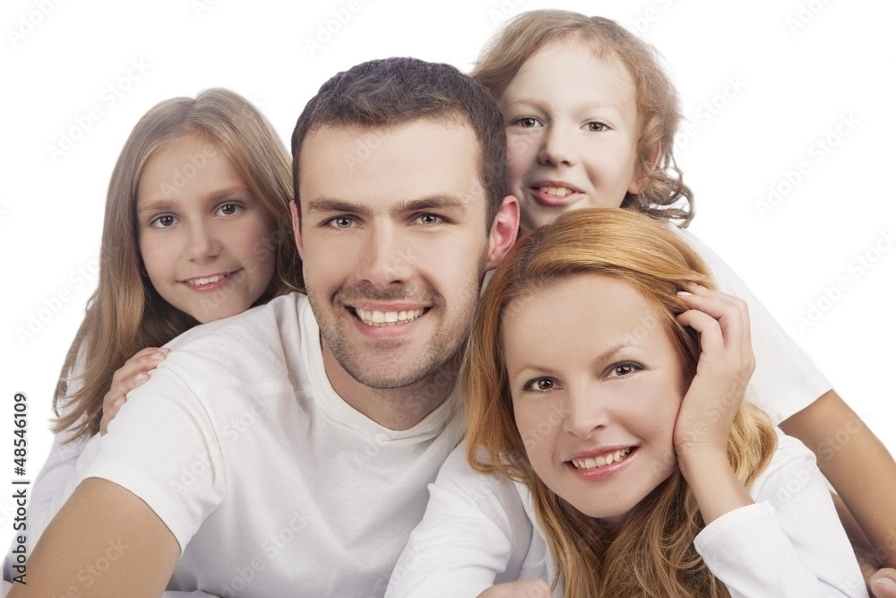 four caucasian family members laying down and smiling